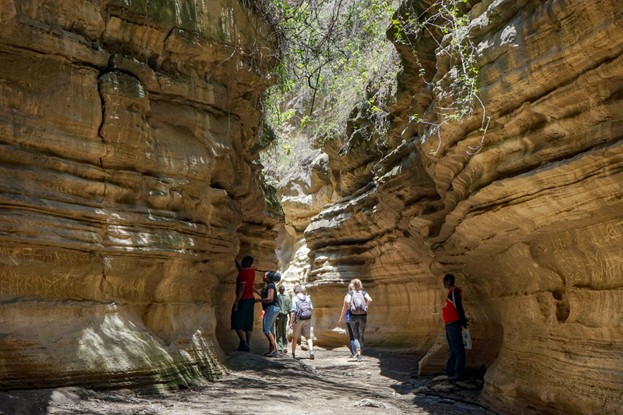 Group of travellwes enjoying a corporate retreat in Kenya's Hell's Gate gorge on a bright sunnyday