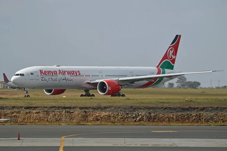 Kenya Airways plane on the runway on a clear sunny day