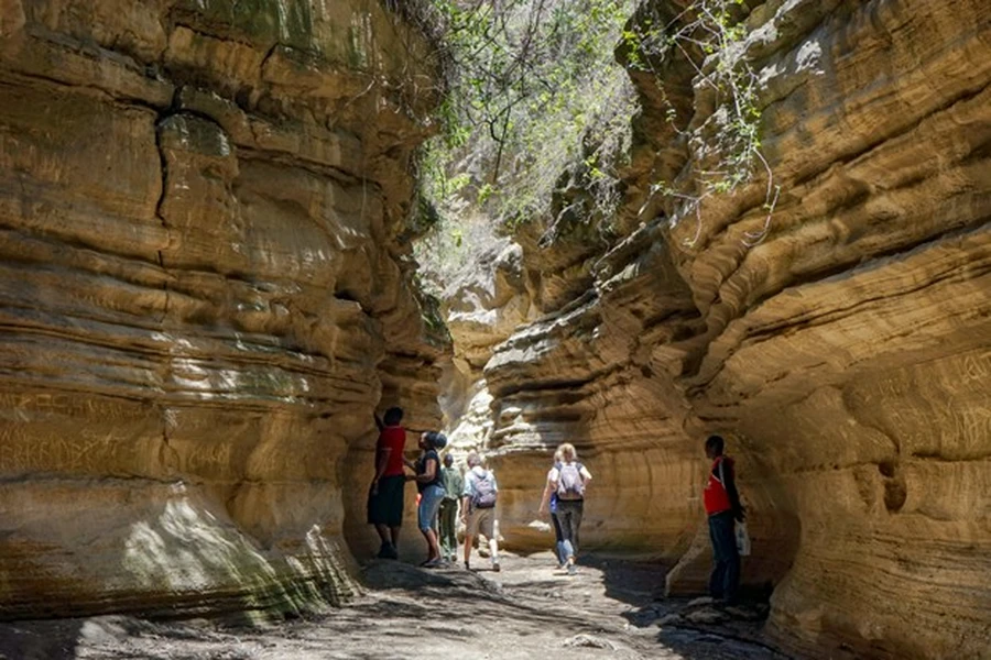 Group of travellwes enjoying a corporate retreat in Kenya's Hell's Gate gorge on a bright sunnyday