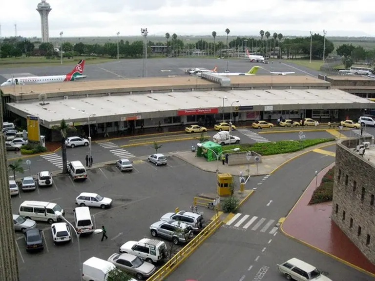 Jomo Kenyatta International Airport domestic departures area parked taxis and airplanes on runway.