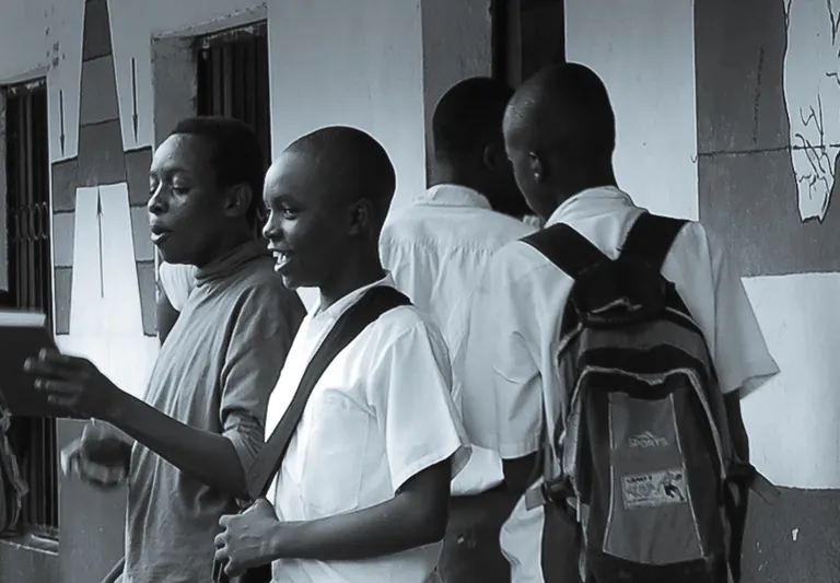 School students learning from an expert guide on a school trip. Black and white picture