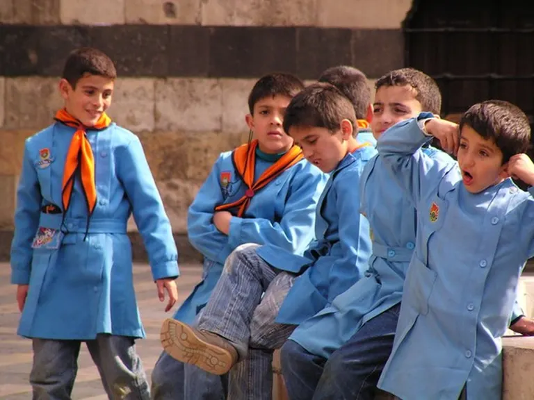 A group of international school kids on Safari, enjoying a school safari trip. One holding his ears