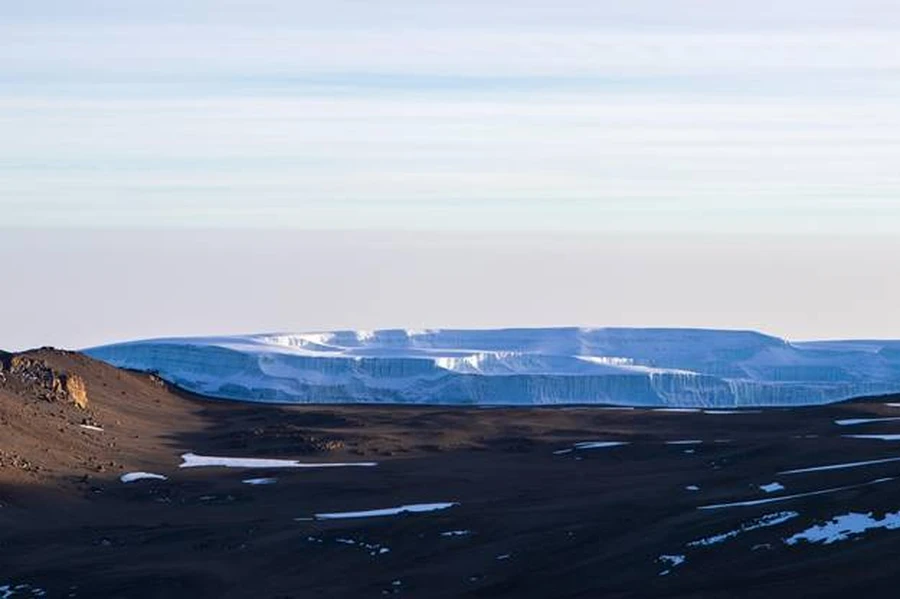 Ice glaciers on Mount Kilimanjaro summit, Uhuru peak, during the morning. Sun shining on summit.
