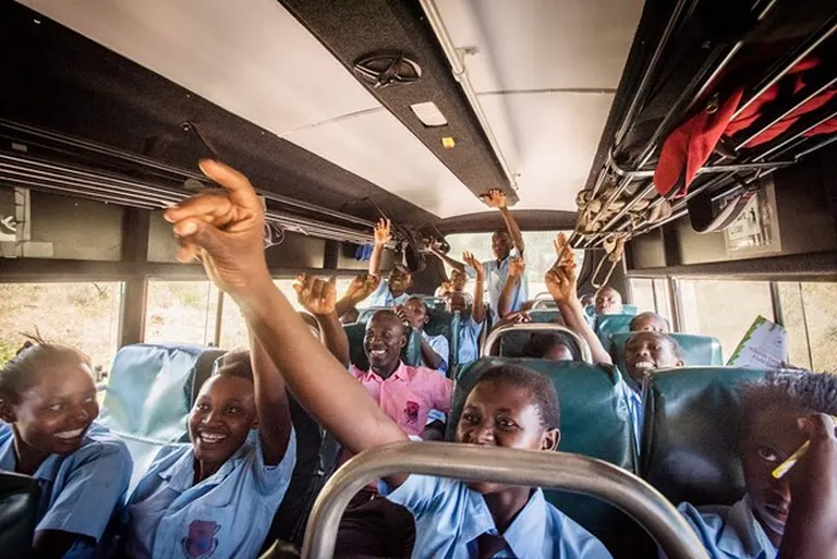 A Group of students in a school bus, excitedly heading for a school trip and educational safari