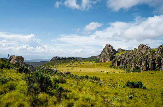 The vast landscape of Aberdare National Park showing hills, cliffs, jagged rocks, and green plains