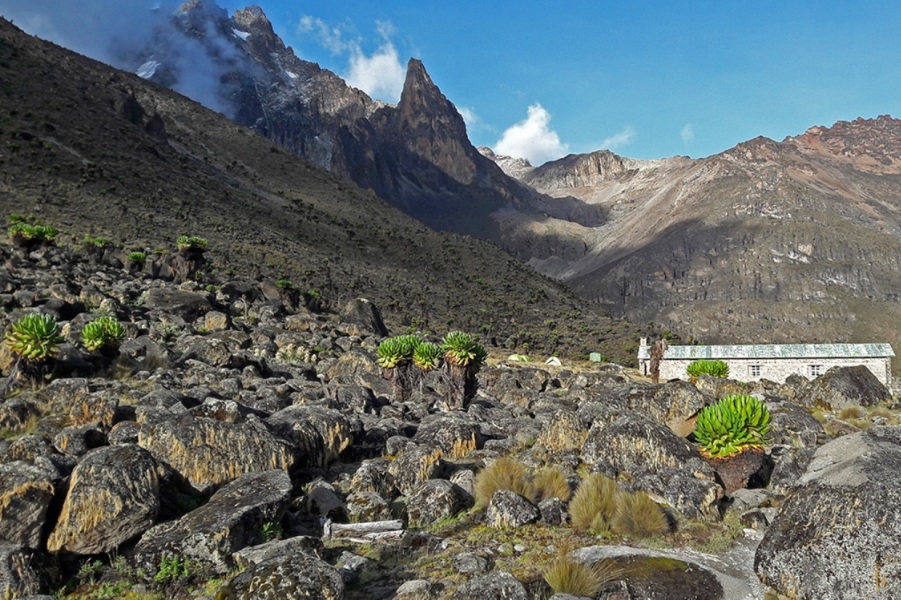 Rugged terrain of Mount Kenya Naro Moru route with Met Station Cabin and peaks in the distance