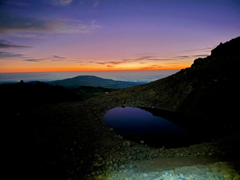 Scenic sunrise over alpine tarn and rugged peaks captured during a Mount Kenya trekking tour