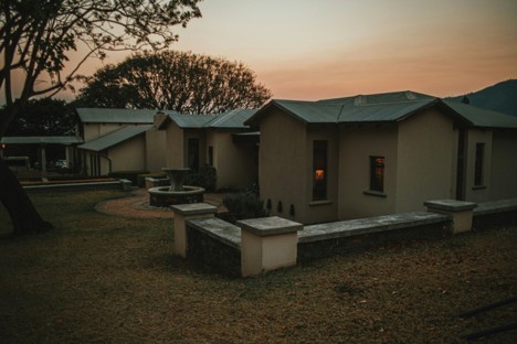 A boutique safari lodge in a Kenyan national park with green outdoor space and trees around